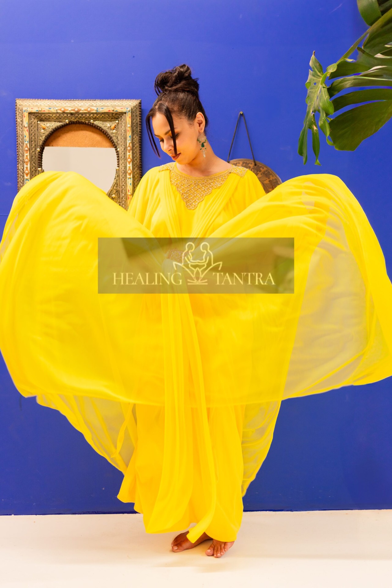 Saffron silk in motion against indigo wall