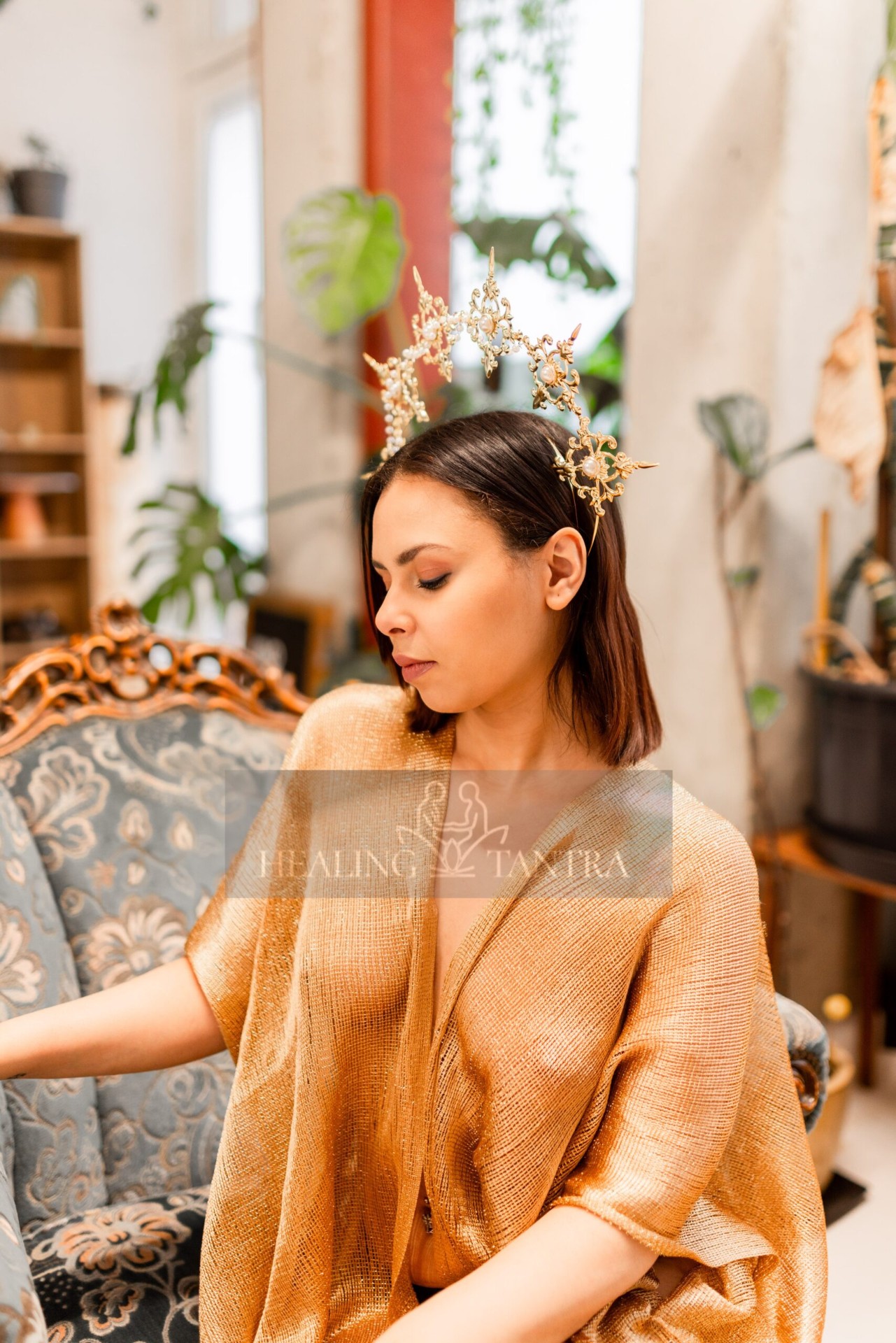 Elira seated in flowing gold