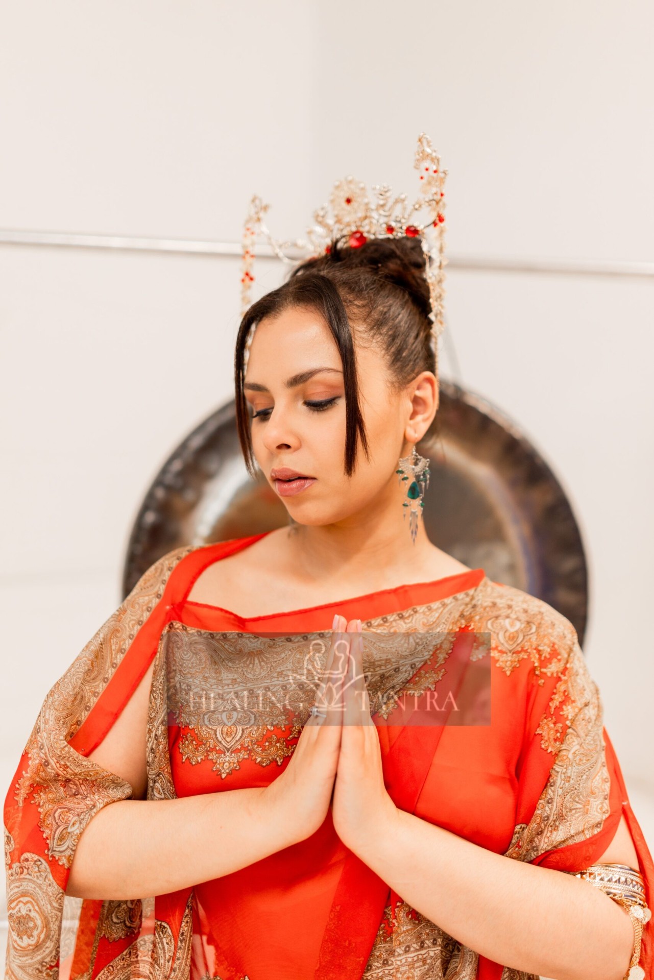 Hands gently pouring warm coconut oil during a tantric ritual