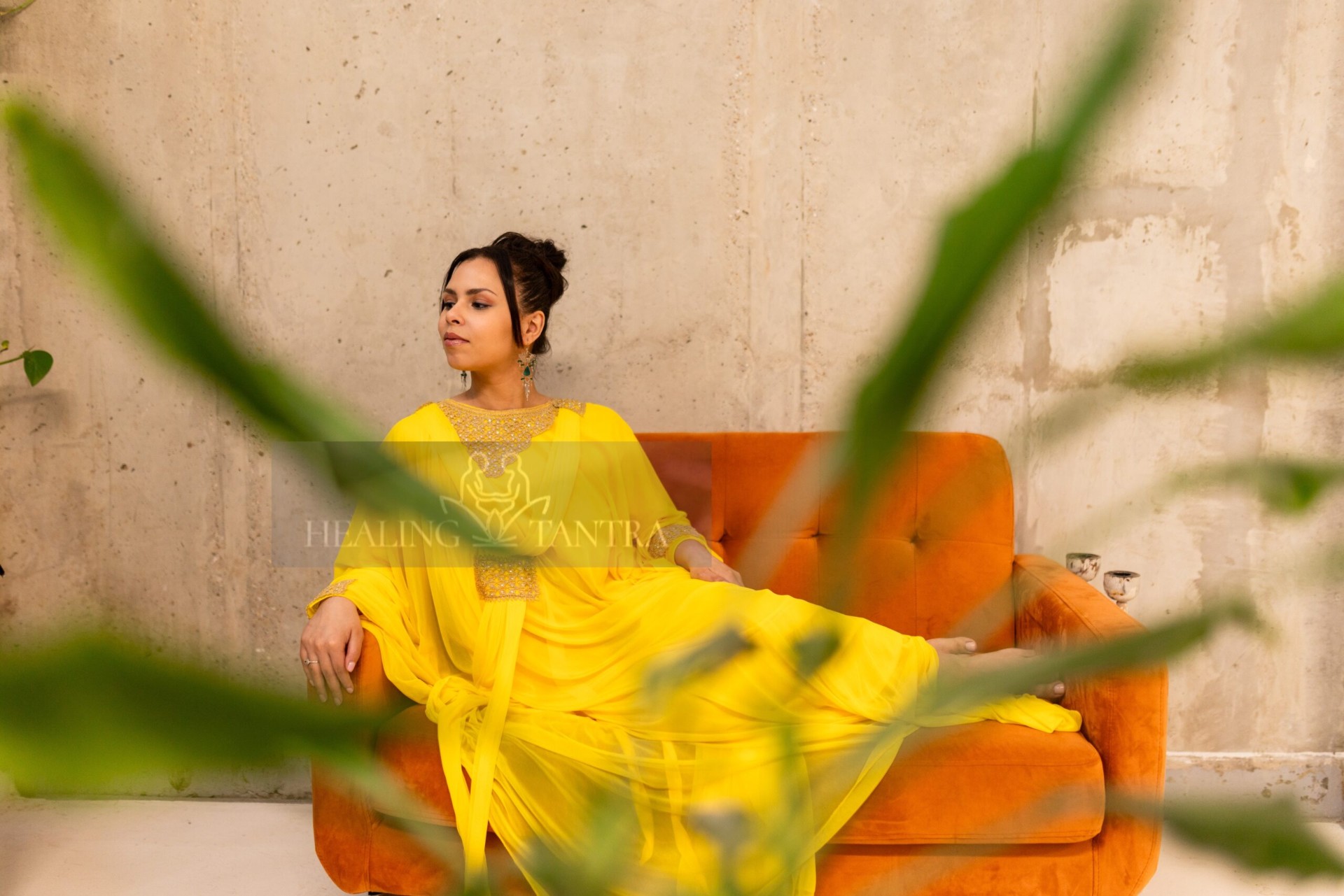 Elira reclining on amber sofa